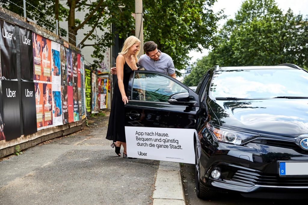 Passagiere schauen sich ein über Uber vermitteltes Fahrzeug an